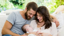 parents holding baby